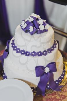 Great wedding cake with purple decorations.