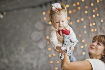 A young mother holding her baby in her arms.