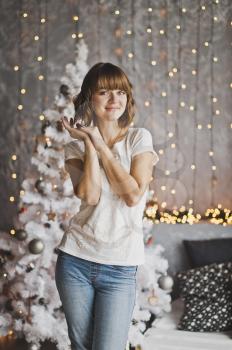 Portrait of girl with beautiful bokeh from the Christmas lights.