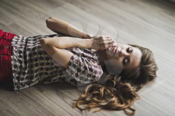 The girl in a fit of tenderness lying on the floor.