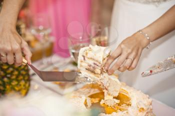 Wedding cake is divided into pieces for the guests.