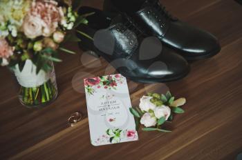 Tie, rings, and shoes with a boutonniere.