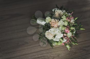 Original wedding bouquet of miniature roses and greenery.