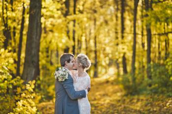 Young couple hugging on the background of Sunny autumn forest.