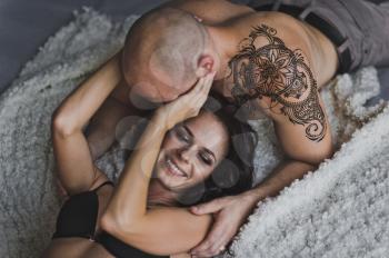Close-up portrait of happy couple in their underwear.