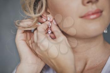 Girl shows her beautiful earrings.