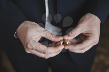 Wedding rings in mens hands.