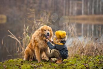 Little lady walking a big shaggy dog.