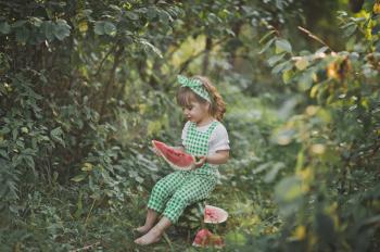 Girl with watermelon in nature.