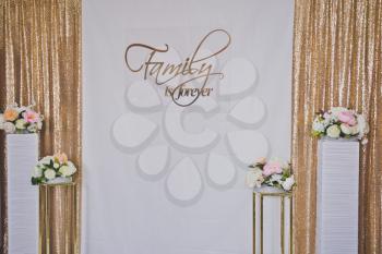 Background for the ad decorated with flowers and fabric.