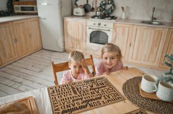 Two little girls host the kitchen preparing a surprise for the holiday.