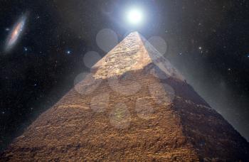  Pyramids of Giza in the background of the starry night sky. Elements of this image furnished by NASA