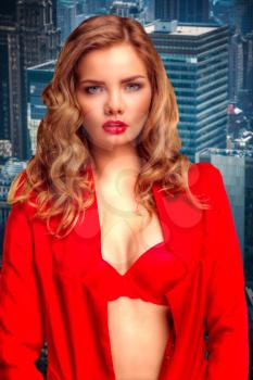 girl in a red jacket and bra standing on a rooftop in New York