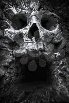cave in the mountains, a human skull. fantastic picture