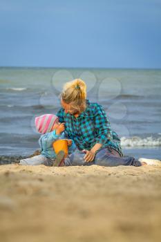 Mother And Daughter On Holiday Standing On Winter Beach