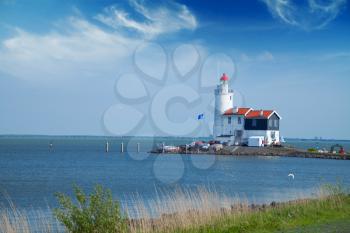 lonely lighthouse stands on the spit in the sea near the village of Marken. Near Amsterdam