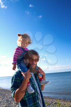Dad and daughter at the sea walk by the sea. Family