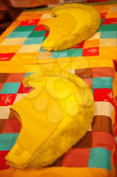 yellow cap monks of the Gelug school. lie on a table with an ornament.