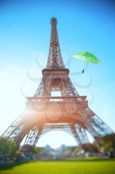 umbrella flying through the air against the backdrop of the Eiffel Tower. Summer trip to France in Paris.