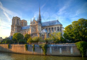 Gorgeous sunset over Notre Dame cathedral with puffy clouds, Paris, France