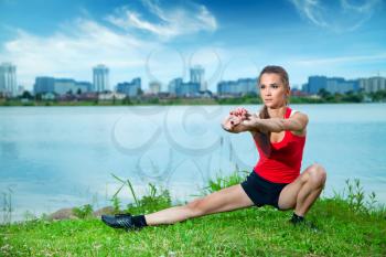 beautiful girl engaged in fitness makes the river in the summer evening. Lifestyle