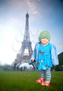 little girl on the background of the Eiffel Tower. small French two years on a sunny day walking around Paris