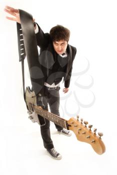 funny and charismatic guitarist in a suit with guitar