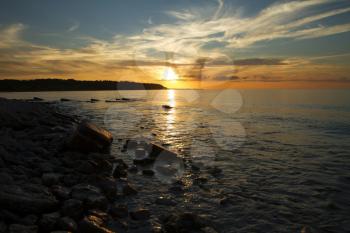 sunset on the sea. red and orange sun and blue water