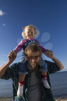 Daughter and dad relax on the beach. family holiday