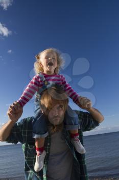 Daughter and dad relax on the beach. family holiday