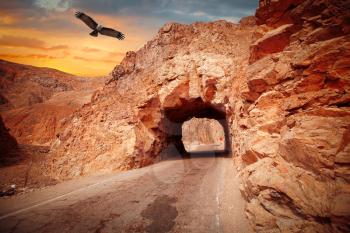 way through the cave in the mountain. The Andes, the Atacama, Peru. eagle flies in the sky.