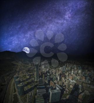 Panoramic view of Santiago de Chile and Los Andes mountain range. night, the starry sky and the moon shine.