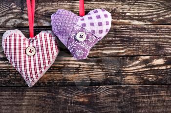 color hearts from textile on wooden background