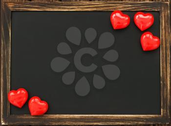 hearts and blackboard on the wooden background