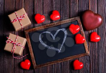 red hearts and black board on a table