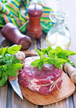 raw meat with spice and herb on a table