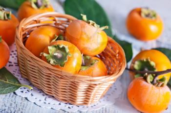 persimmon in basket and on a table