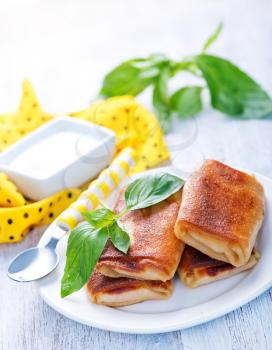 pancakes with meat and fresh basil on the plate