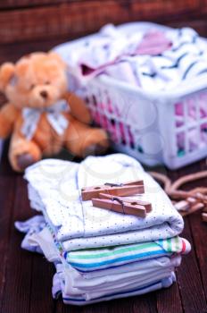 Clear baby clothes on the wooden table