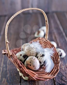 raw quail eggs in the basket and on a table