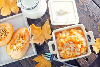 pumpkin porridge in the bowl and on a table