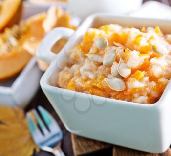 pumpkin porridge in the bowl and on a table