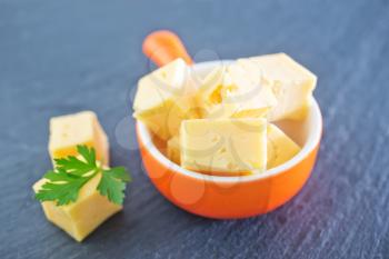 cubes of cheese in the bowl and on a table