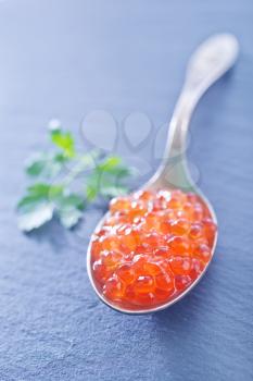 red salmon caviar in the metal spoon