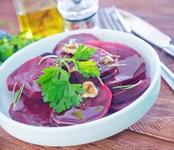 boiled beet with oil in the white plate