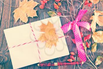 envelope on the wooden background,envelopes and autumn leaves