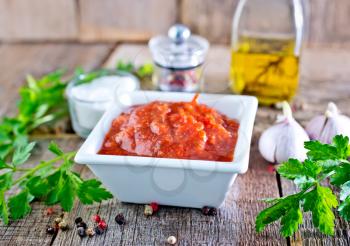 tomato sauce in white bowl and on a table