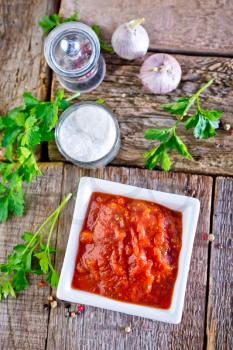 tomato sauce in white bowl and on a table