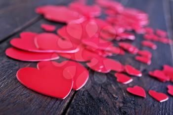 red hears on the wooden table, hearts on wood