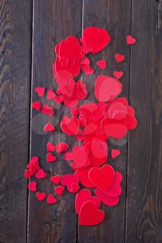 red hears on the wooden table, hearts on wood